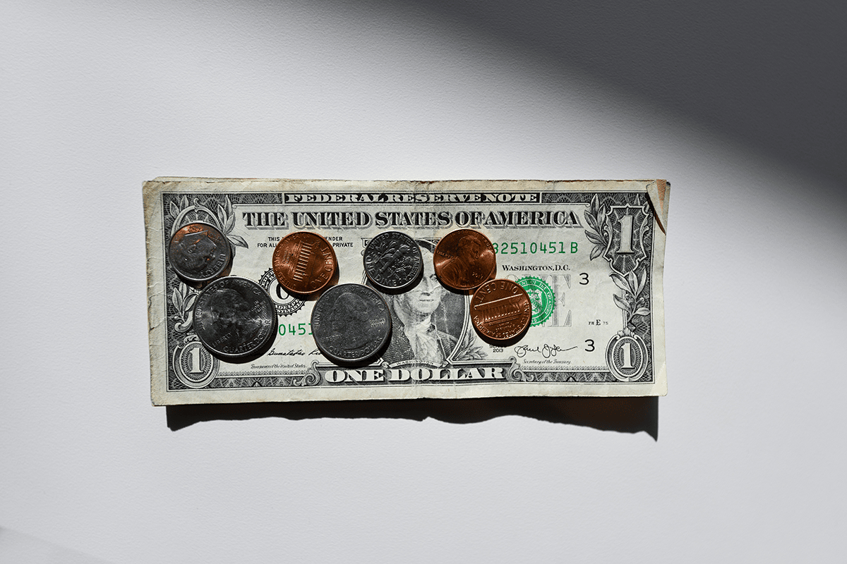 dollar bill with coins on top of it