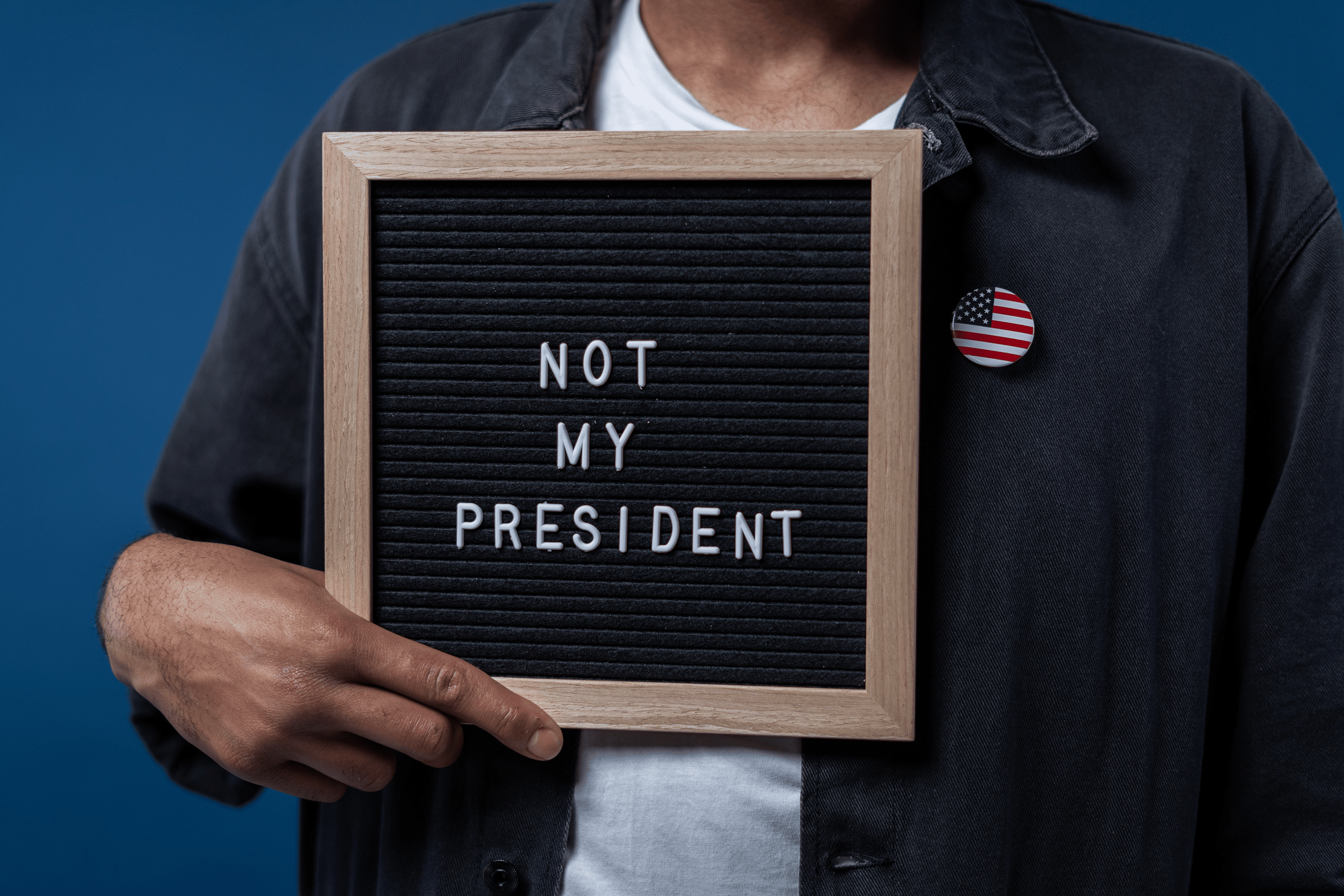 man holding not my president sign