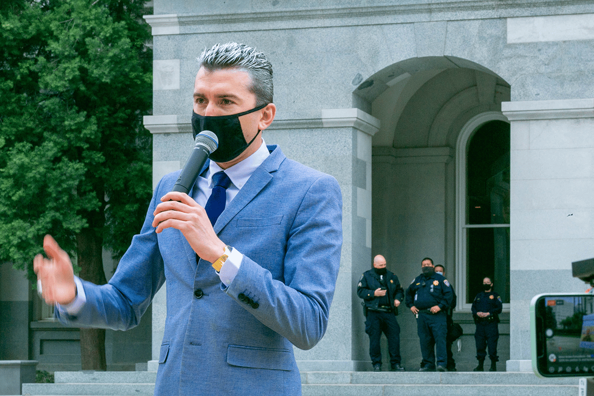politician speaking with mask on
