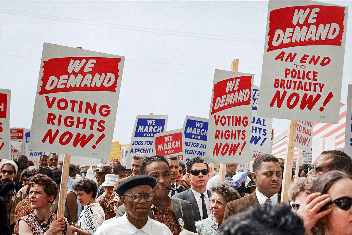 protesters with we demand voting rights sign