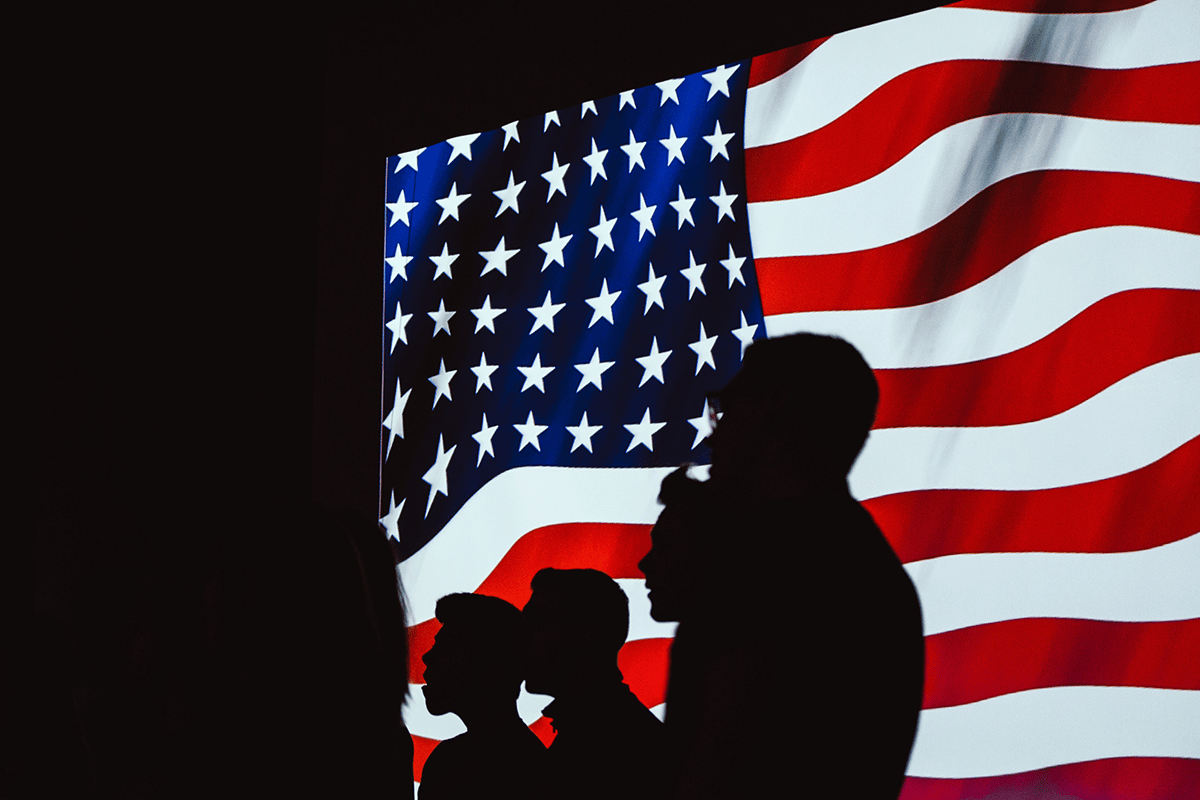 silhouette of man in front of american flag