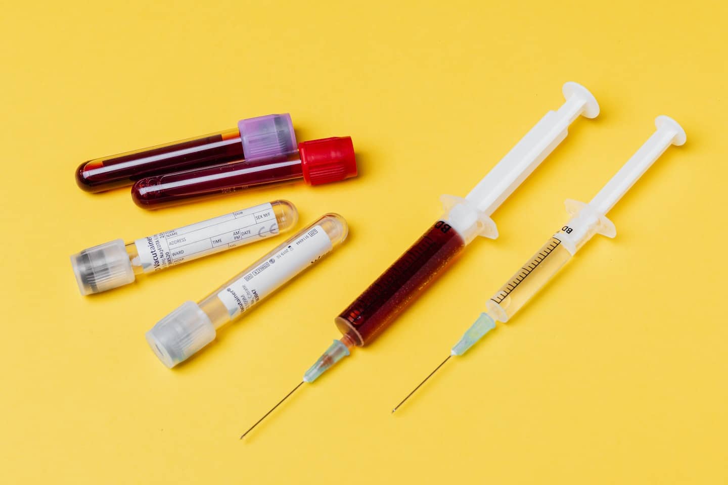 vials and hypodermic needs filled with blood samples