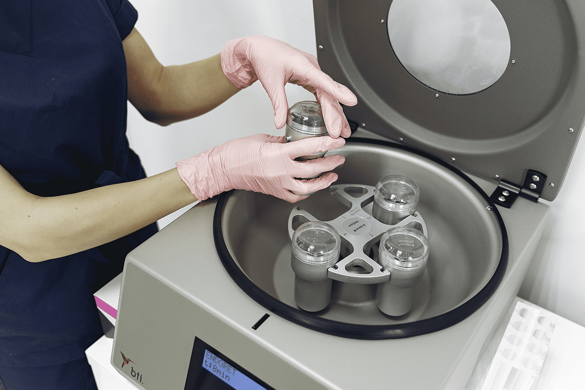 woman using a centrifuge for blood samples