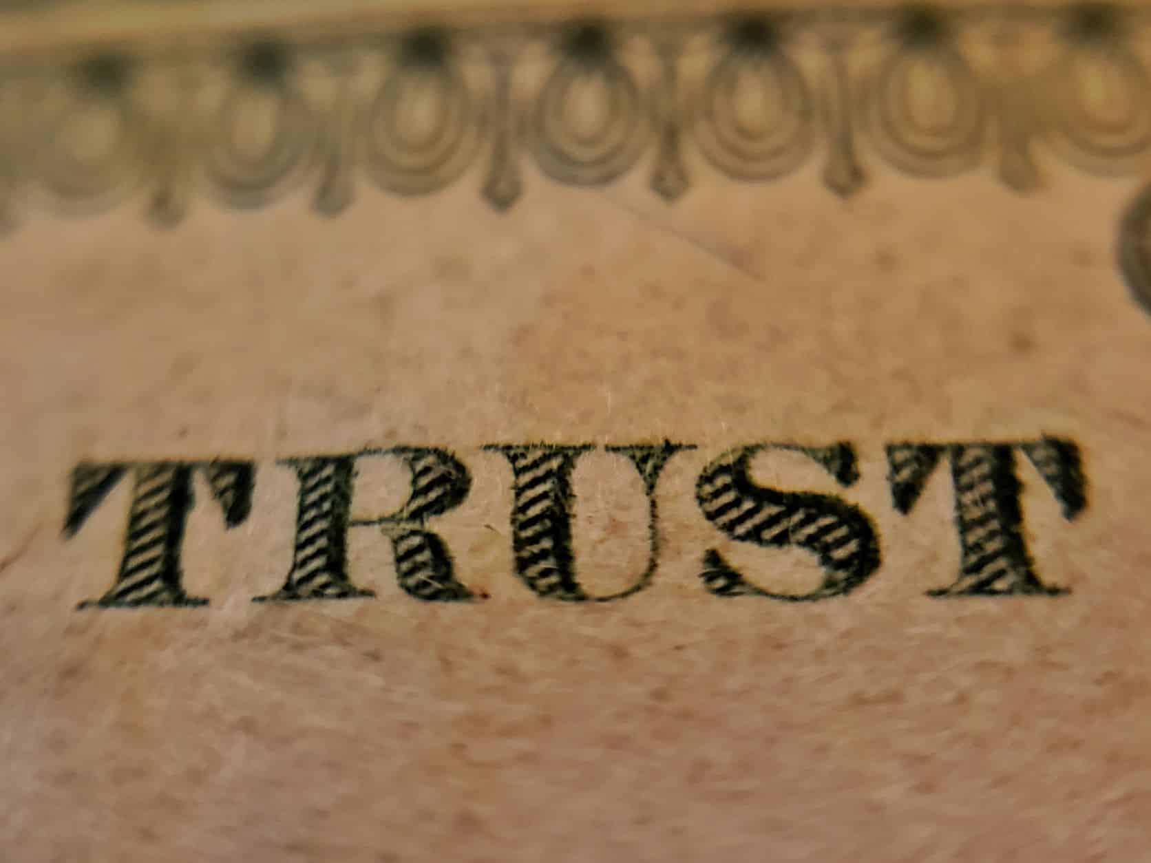 closeup of the word trust from an American dollar bill