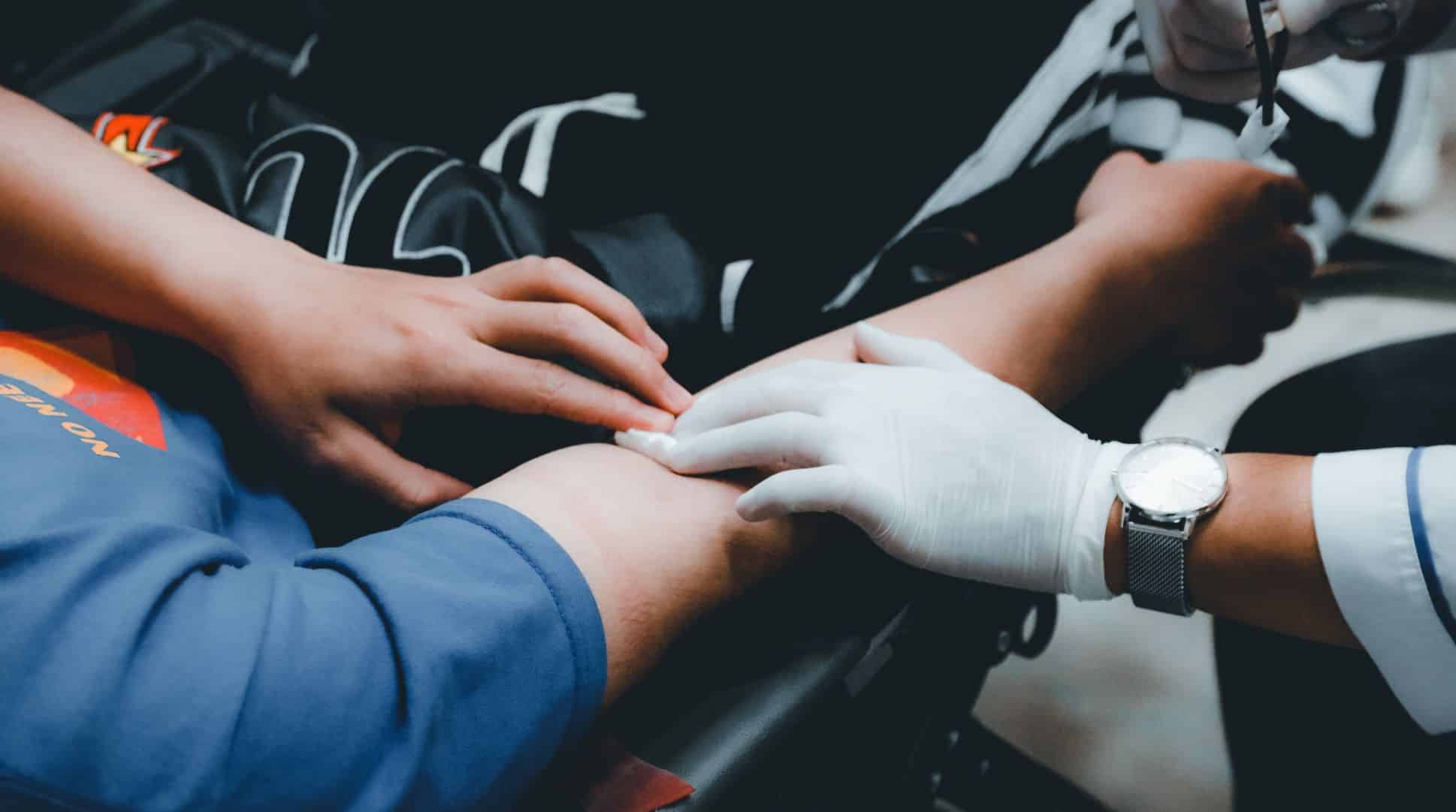 doctor holding bandage on patients arm