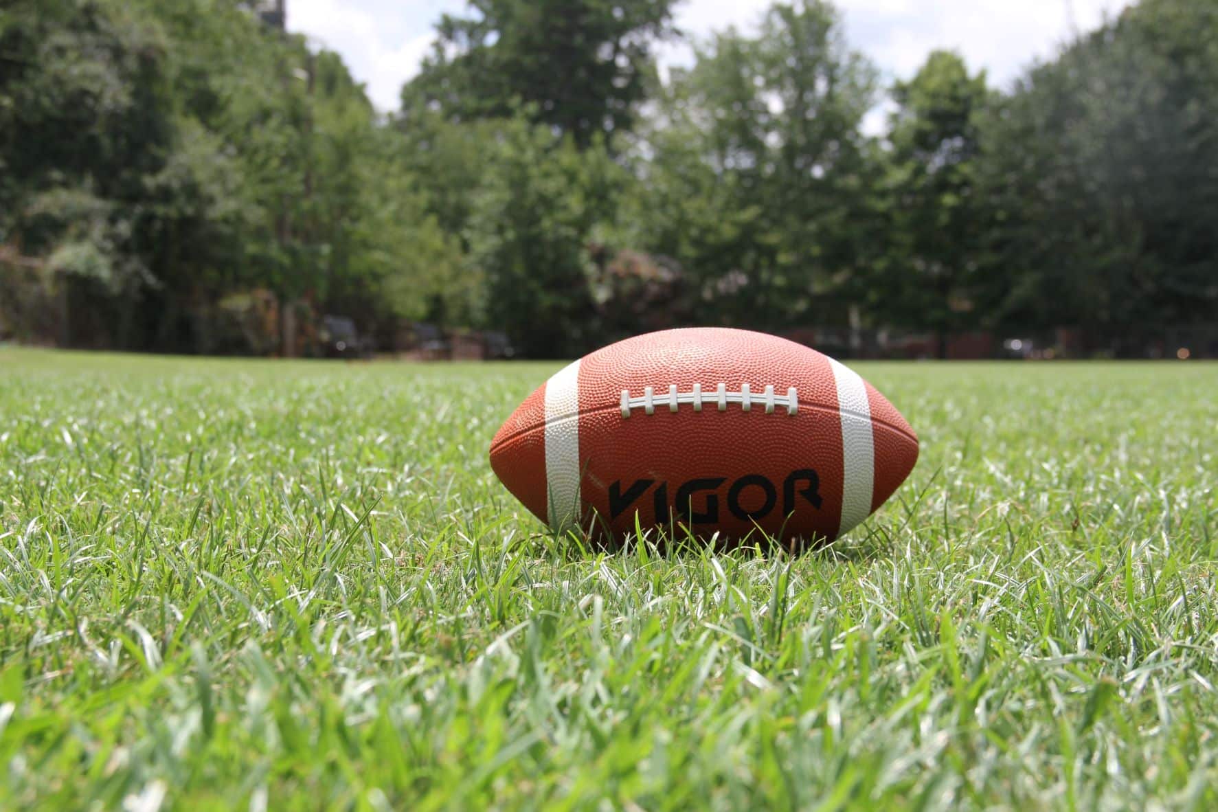 football laying on open grass field