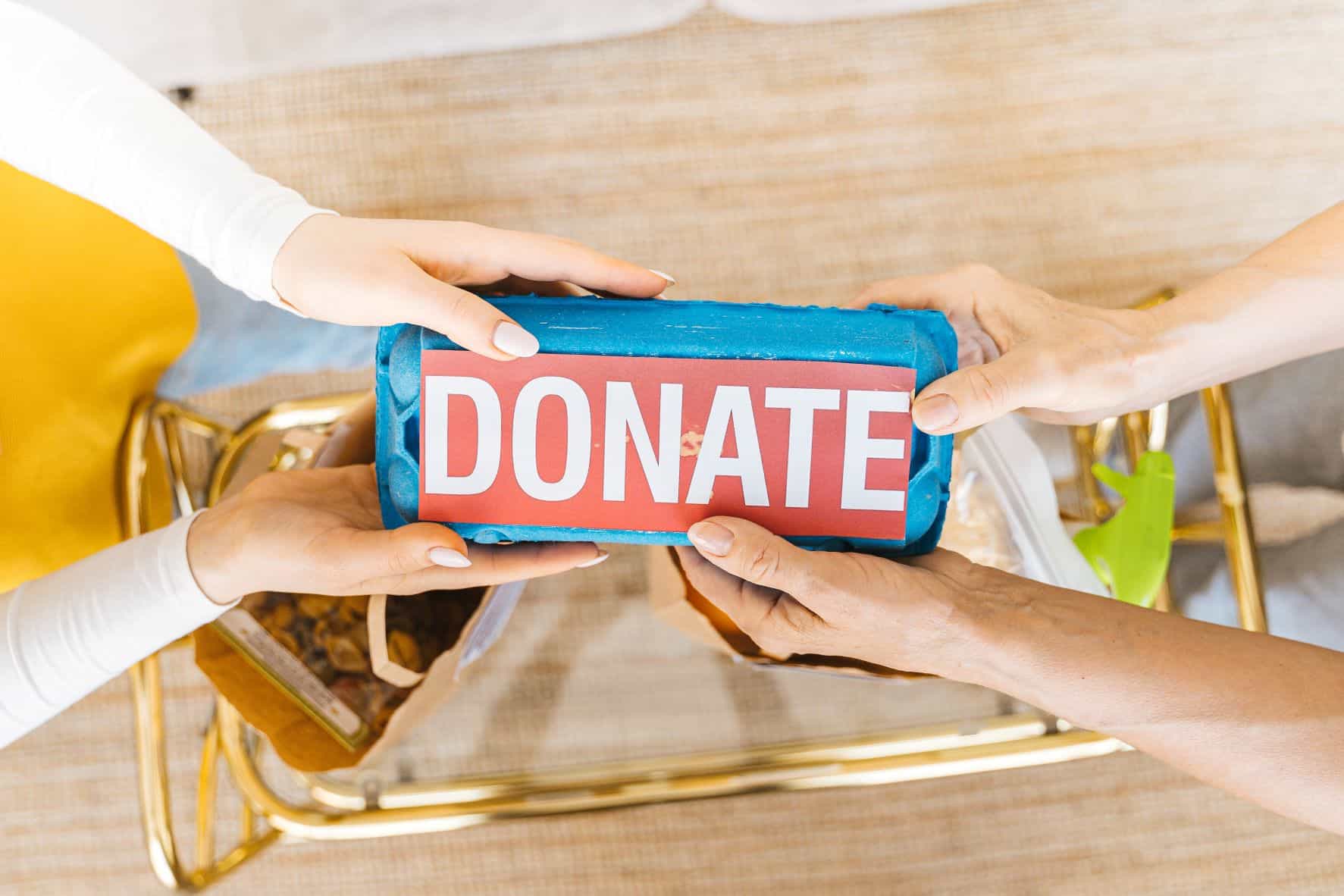 hands holding a donate sign