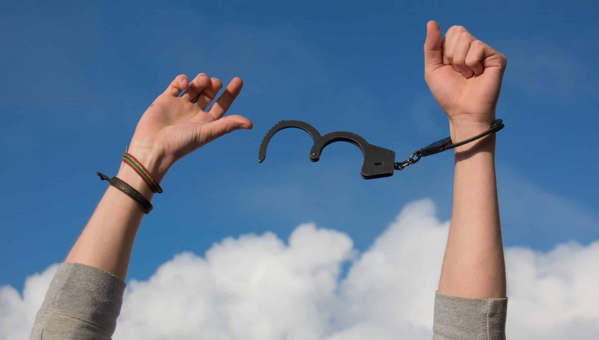 person breaking free from handcuffs
