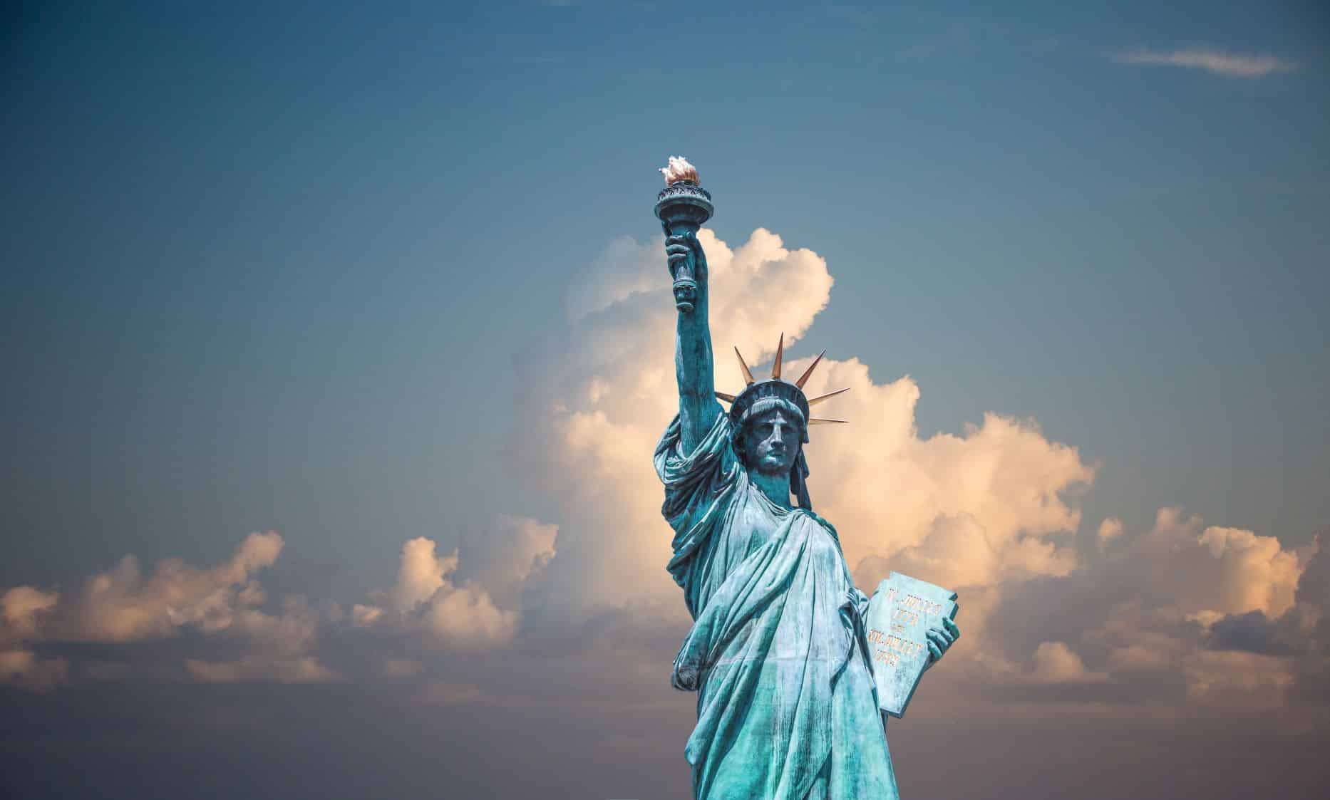 statue of liberty against cloudy sky background