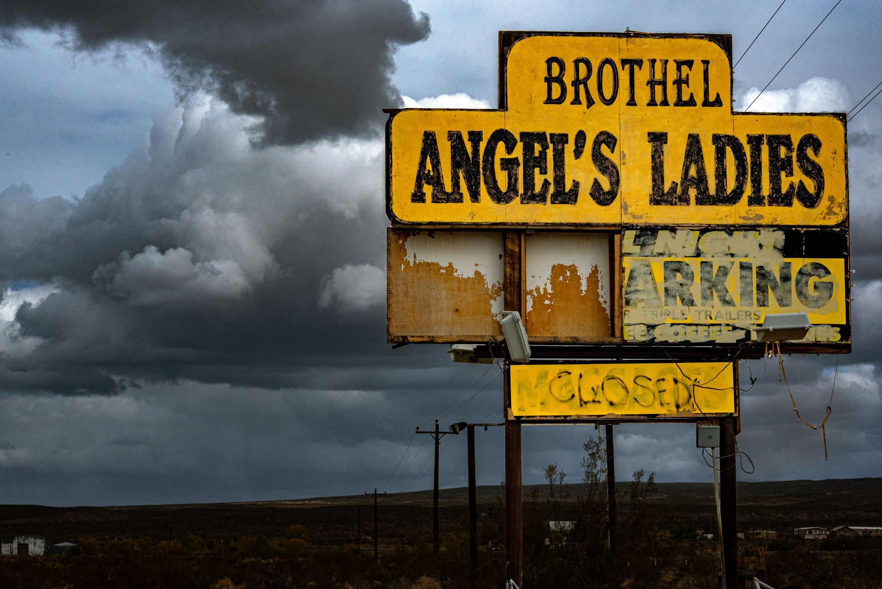 worn sign for brothel called angels ladies