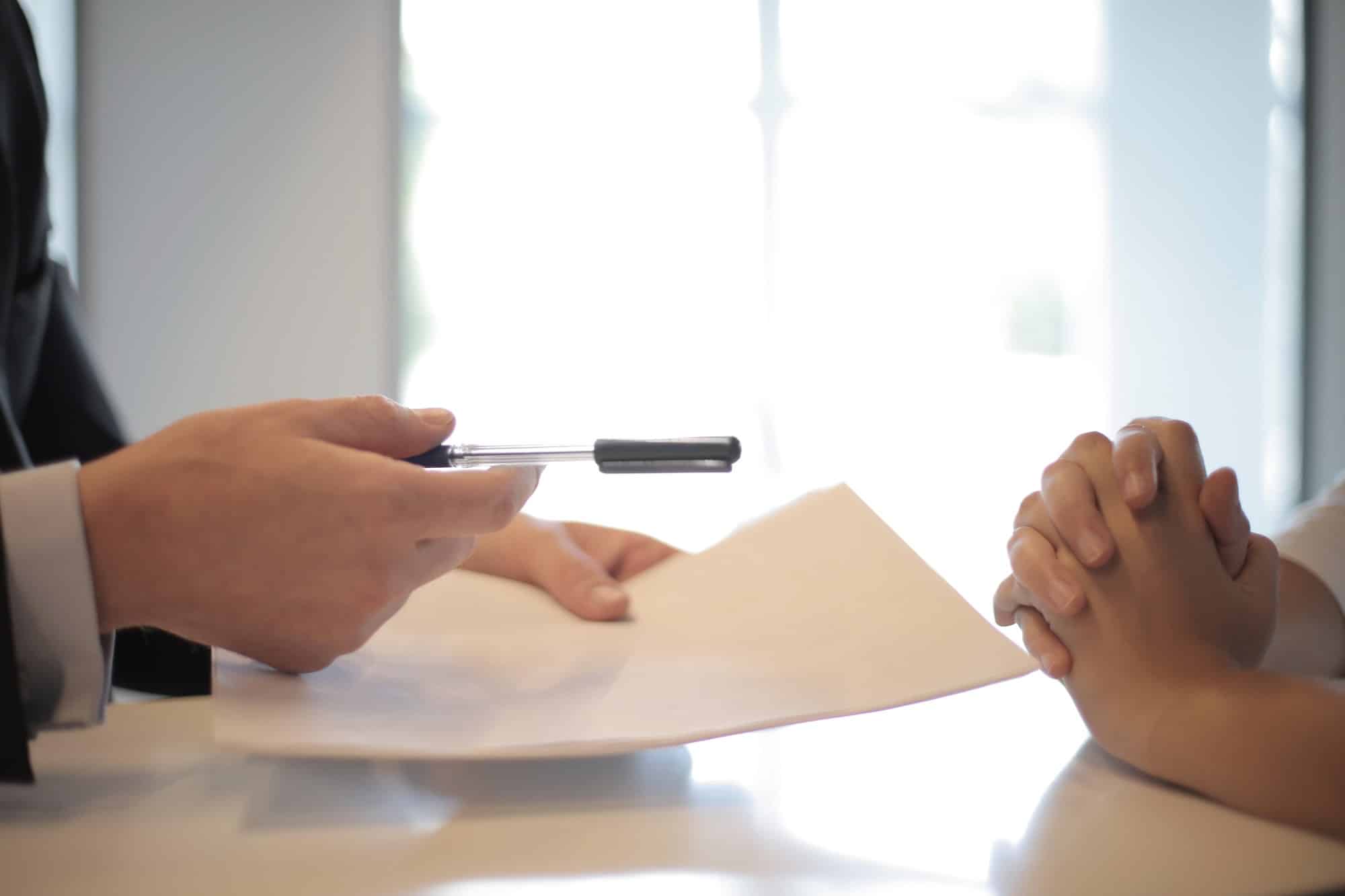 cropped image of man giving contract and pen to woman
