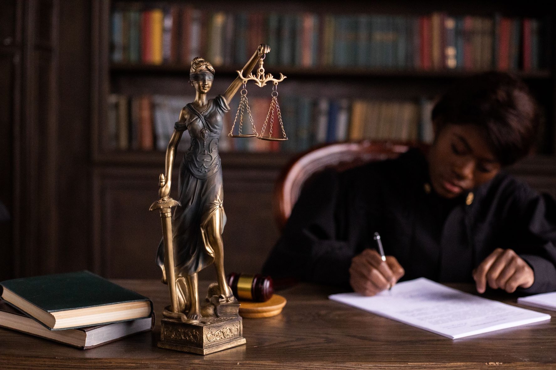 figurine of the lady justice on the table of a judge