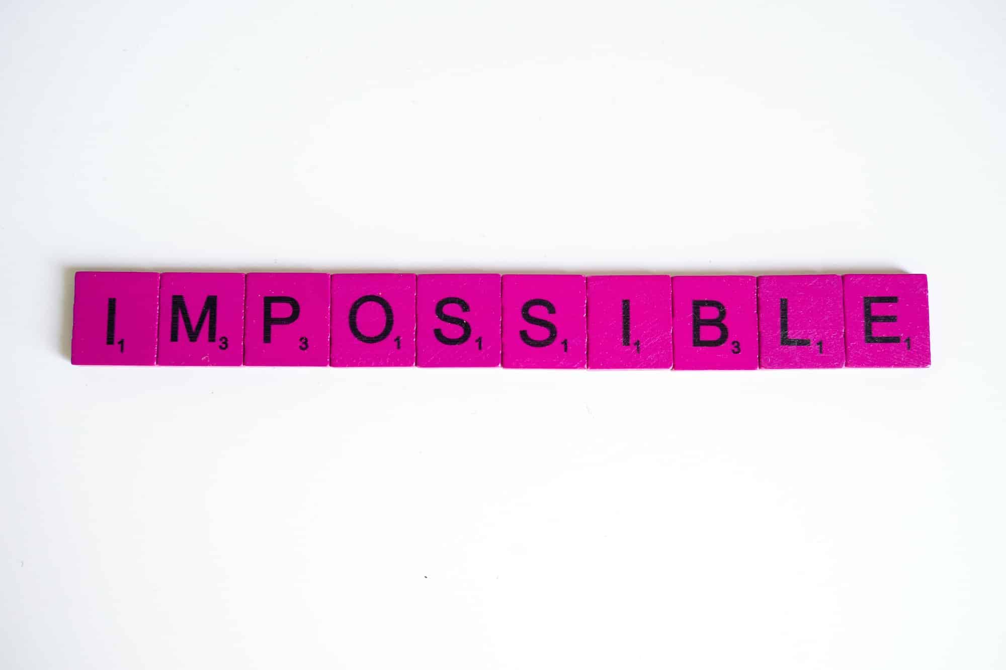 pink scrabble letters spelling out the word impossible