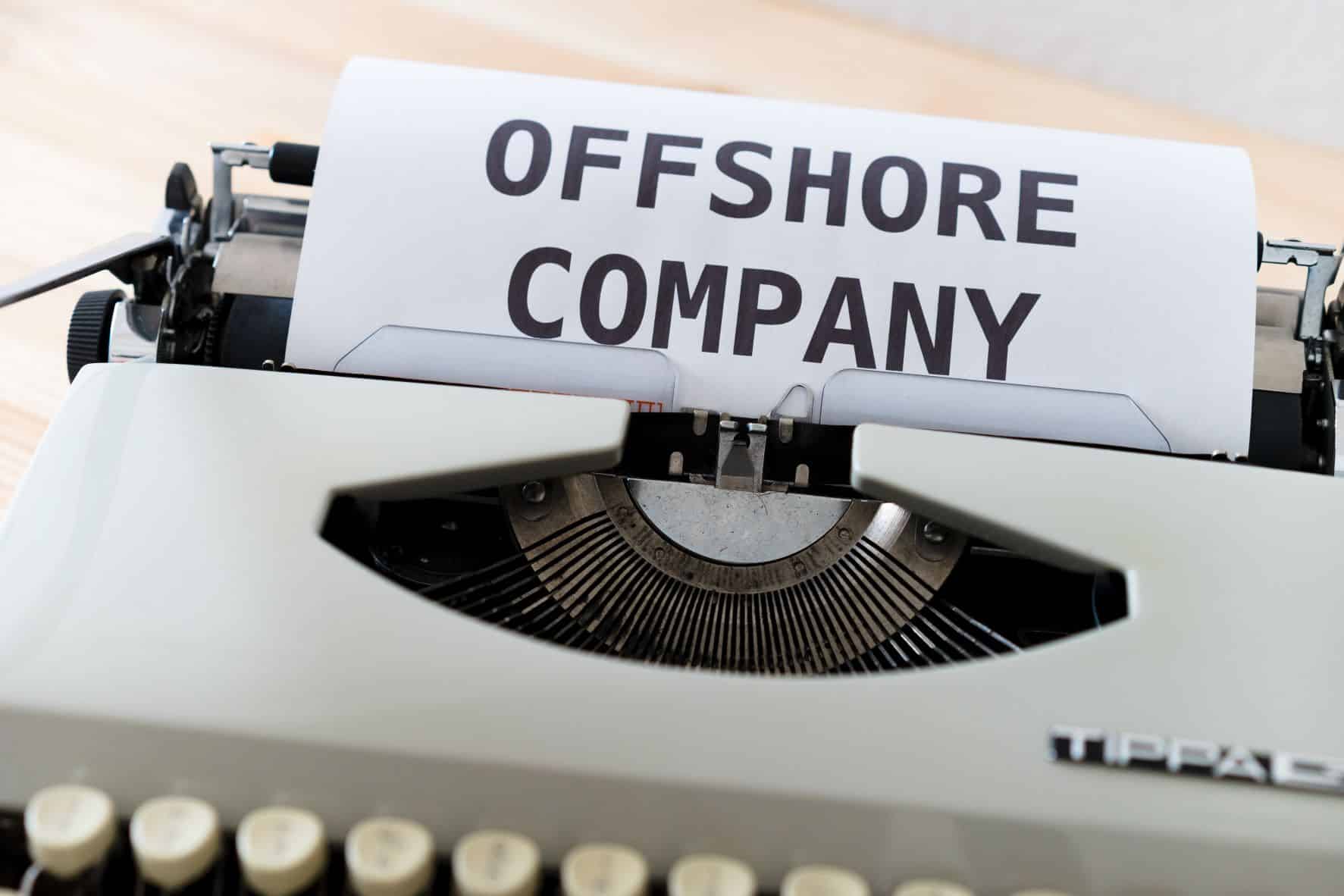 typewriter with piece of paper saying offshore company